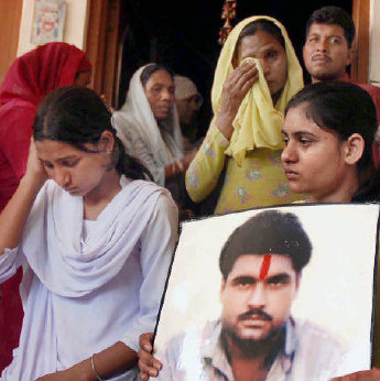 DEJECTED FAMILY: Daughters Poonam and Swapandeep and wife Sukhpreet Kaur of Sarabjit Singh at Bhikhiwind village near Amritsar 