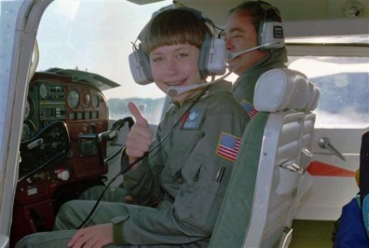 Vicki Van Meter, 11, of Meadville, Pa., gives the thumbs up as she leaves on the first leg of her cross-country flight from Augusta, Maine