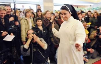 A nun displays an outfit of her order during a church fair held in the catholic university of Lublin
