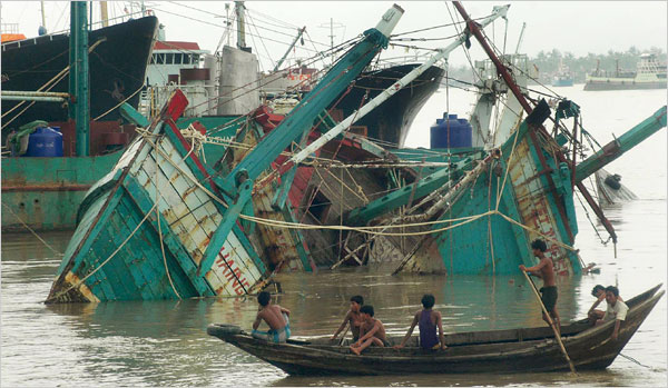 Fishing boats crushed by a tropical cyclone in the port of Yangon, Myanmar, on Sunday. Winds reached 120 miles per hour
