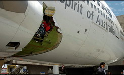 Qantas jumbo jet lands safely after hole ripped into side