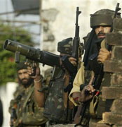 Indian soldiers take positions at the scene of a gun battle in Jammu, 